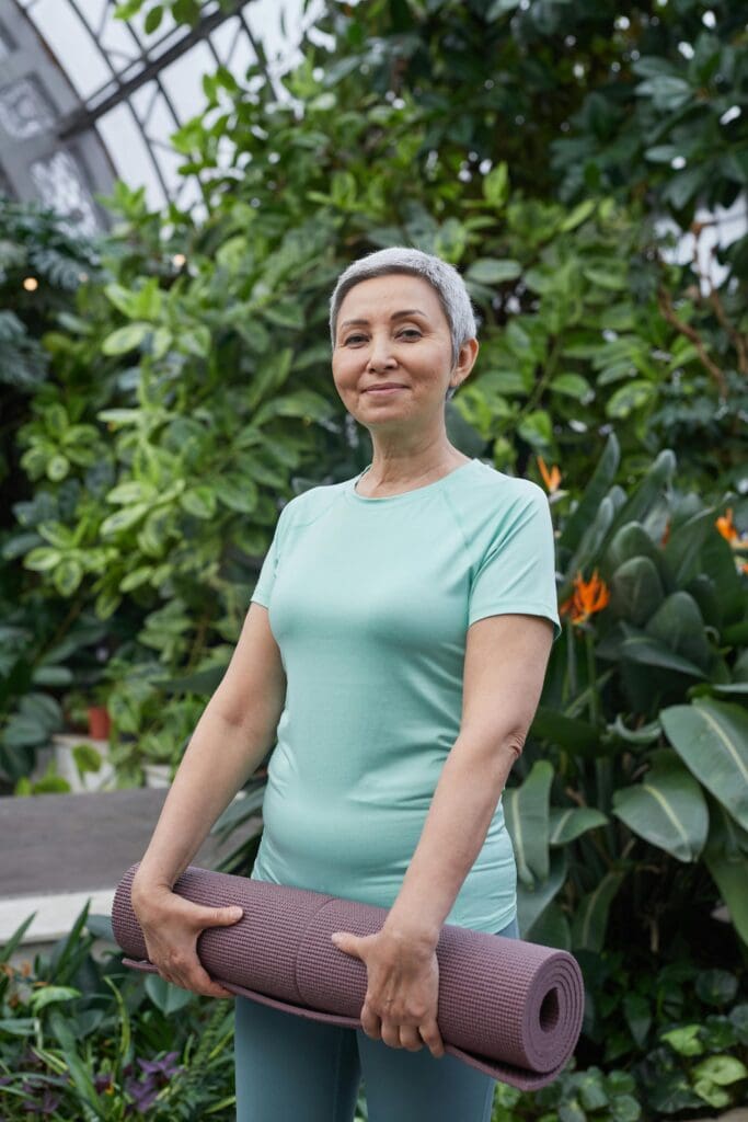 A woman in a green shirt holding onto some flowers