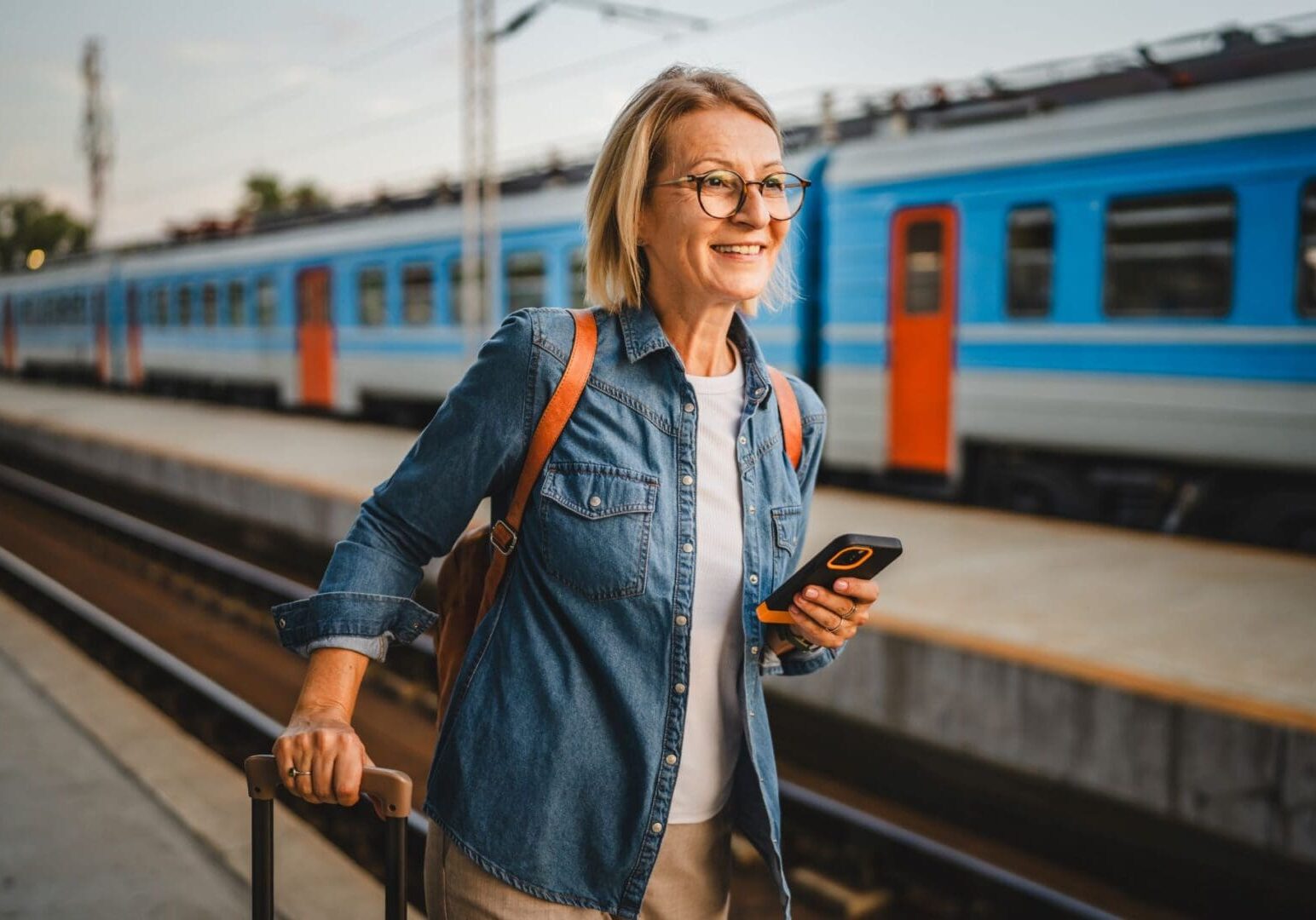 A woman is standing on the train tracks